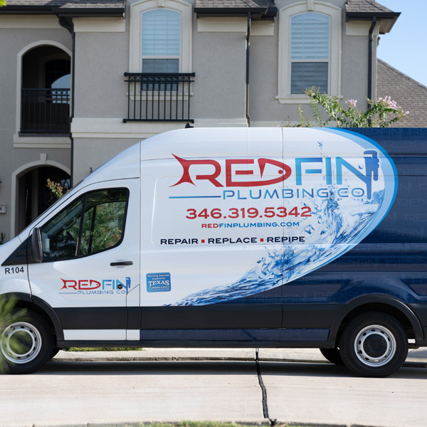 redfin truck parked in front of house