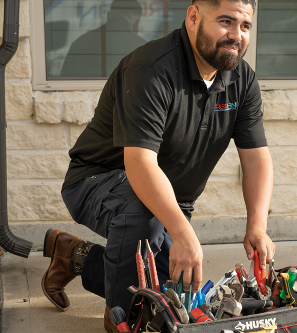technician grabbing tools from toolbag