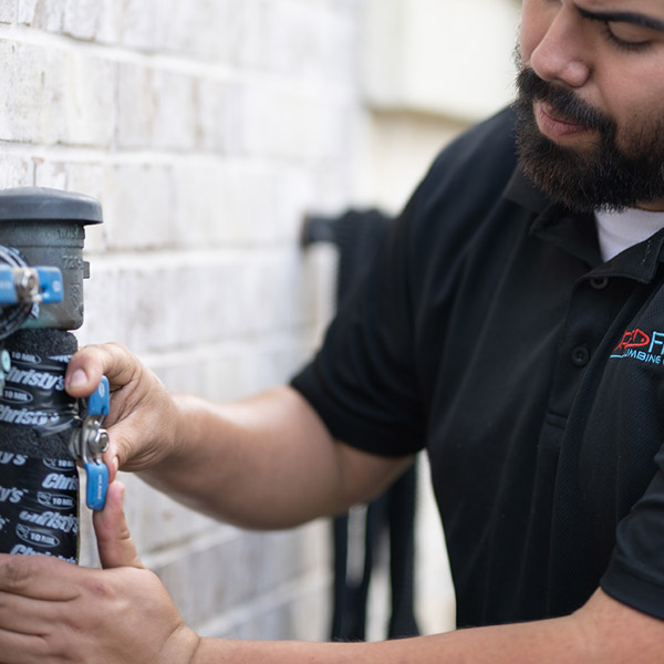 technician working on plumbing repair