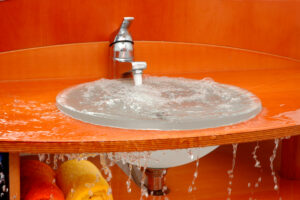 water flows heavily on orange color sink at Houston, TX