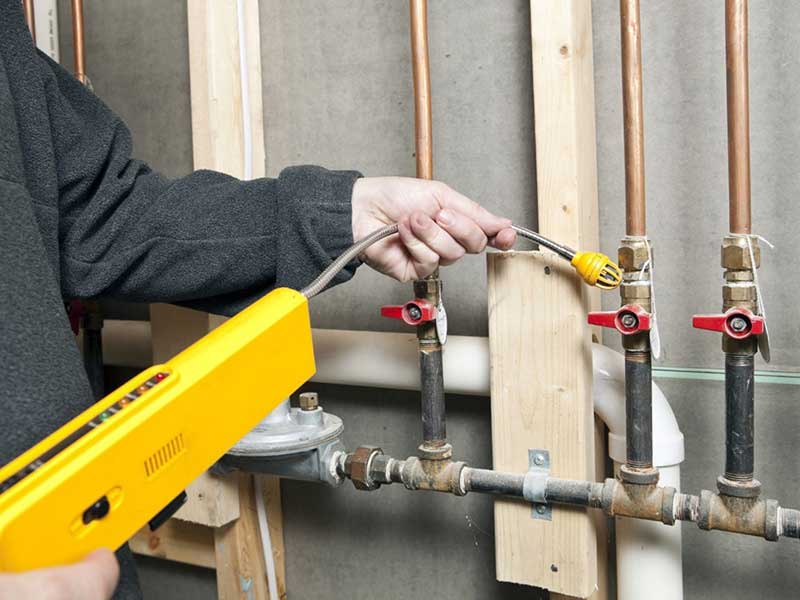 The man checking gas leak with tool at Houston, TX